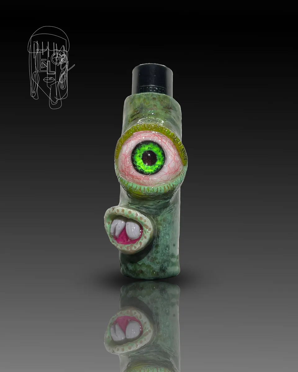 Macro detail of a hyperreal green glass eye set into a sculpted lighter case